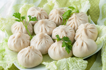 Frozen dumplings on the white plate with green