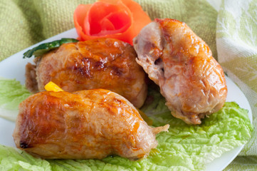 Roll chicken with greens and vegetables on the plate