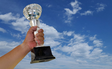 Hand holding Trophy cup