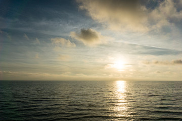 Beautiful beach landscape with sunset sky and soft waves over sand