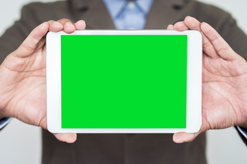Businessman holding digital tablet  with blank screen, closeup