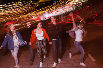 Young people party in city. Free nightlife. Happy students outdoors, strong friendship, bright...