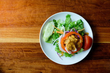  Top view of Delicious  vegetables  Italian salad in dish on wood table