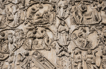 Fototapeta na wymiar ORVIETO, ITALY - JULY 2017- Close-up of the opulent and elaborated embossed sculptures in the Orvieto Cathedral (Duomo)