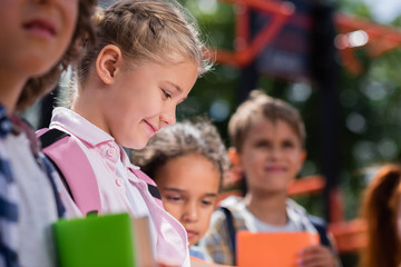 kids with books on playground