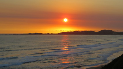 Fototapeta na wymiar Beautiful orange sunset landscape at the sea in South africa. 