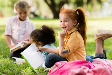 kids reading books in park