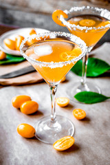 cocktail with kumquat on wooden background