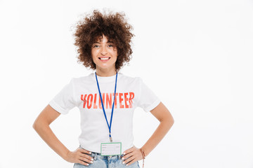 Smiling casual woman dressed in volunteer t-shirt with badge