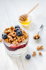 Healthy morning with granola breakfast on white kitchen table