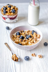 Homemade fitness granola with yoghurt and berries on white kitch