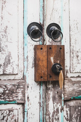Vintage door locker on shabby door with key