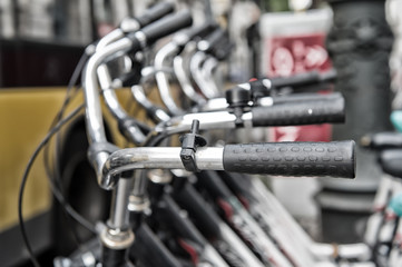 Fototapeta na wymiar Bicycle handlebars or metallic steering wheels in row in Berlin