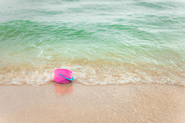 Fototapeta na wymiar Child's play toys buckets on sand at the beach .