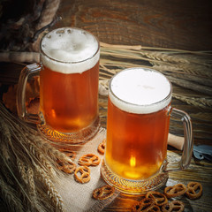 Glasses of fresh beer on a wooden table.