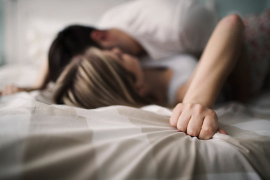 Beautiful couple being romantic and passionate in bed