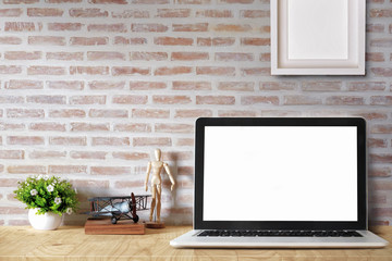 Mock up  Laptop on wood table with vintage airplane toy, dummy, houseplant. desk workspace with copy space for products display montage.