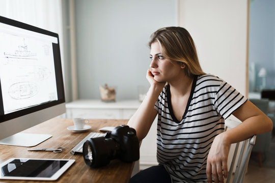 Picture of young female designer working at home
