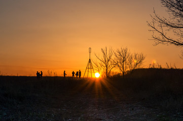 People are taking pictures at sunset
