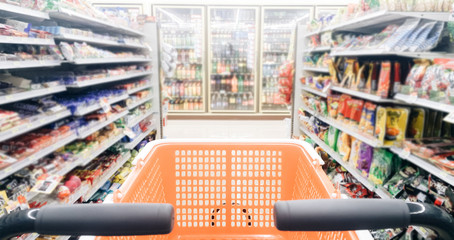Blurred photo of store with empty shopping Cart or trolley in Supermarket store .