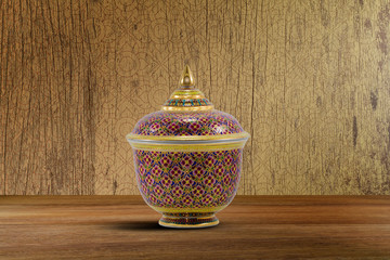 Thai porcelain on vintage wooden tabletop on grunge vintage wooden background with Thai pattern, still life