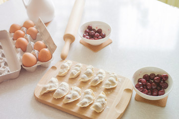 Raw dumplings with cherry, preparation for cooking