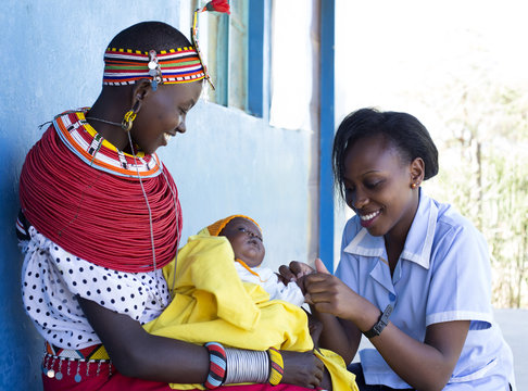 Nurse examing Mother and Baby in clinic. Kenya, Africa