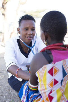 Nurse examining woman in Samburu village