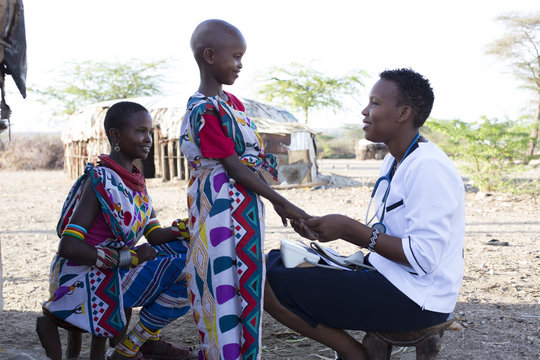 Nurse examining mother and daughter in Samburu village