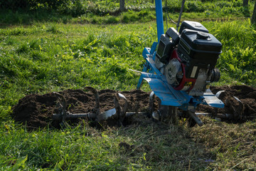 Dumping of land in the garden with a cultivator