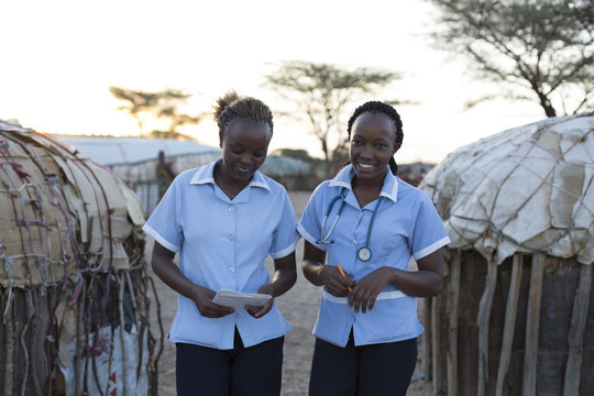 Two Nurses working on location in rural village. Kenya, Africa.