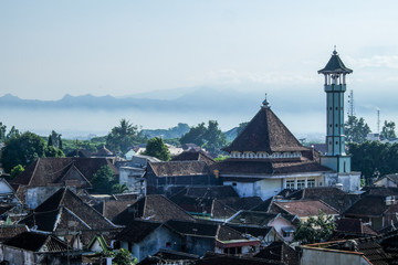 javanese village with pantations, mosque and high active volcanoes in background