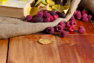 Fresh raspberries on wooden table autumn