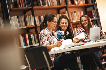 Group of  female students study in the school  library.Learning and preparing for university exam.