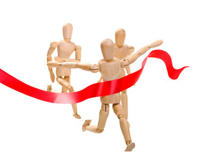 Wooden figure of a man running a leader winner on a white background with red ribbon. Business, sport. success concept