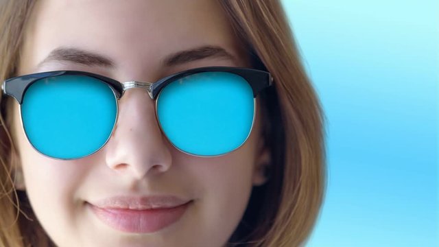 Cinemagraph - Beautiful young girl in the sunglasses . Motion Photo.