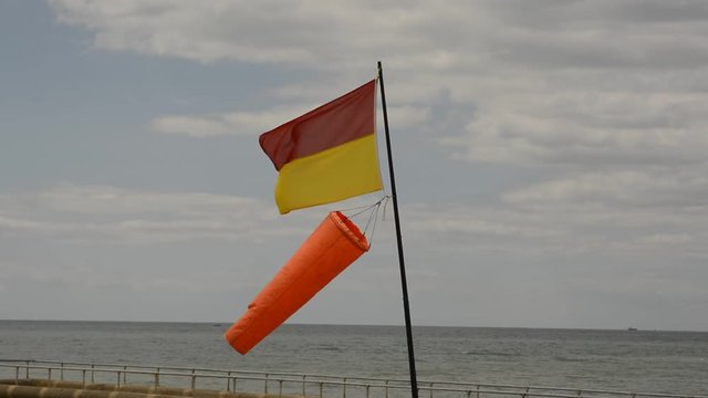 Flag and Windsock on Brighton Beach, England, showing lifeguard area