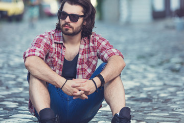 Young man posing in front of the camera.