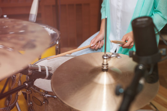 Woman playing the drums, studio recording/rehearsal time