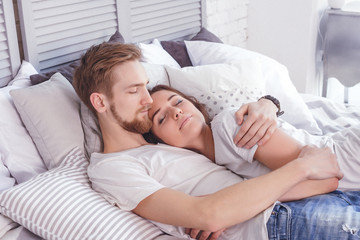 Young loving couple in the bed