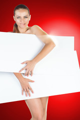 Beautiful young woman with a white empty blank pose in the studio on a red background