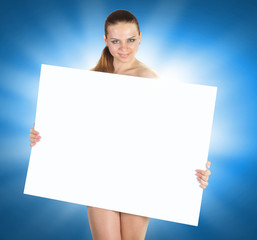 Beautiful young woman with a white empty blank pose in the studio on a blue background