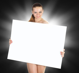 Beautiful young woman with a white empty blank pose in the studio on a black background