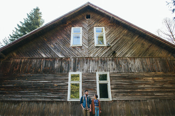 man with woman standing under crown of green tree on street