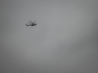 Helicopter flying in a grey sky
