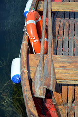 boat rescue tire and paddle in color red close up photo