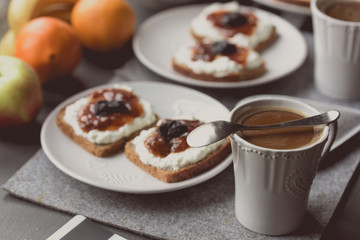 Breakfast with dark bread, white cheese , jam and coffee.  