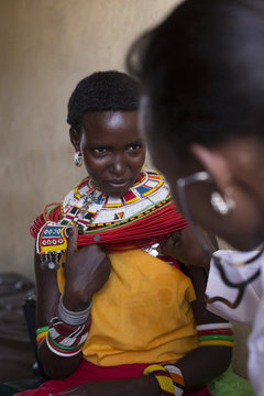 Female Doctor examining female Samburu patient. Kenya, Africa