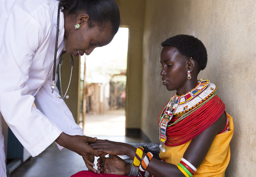 Female Doctor examining woman from Samburu tribe. Kenya, Africa.