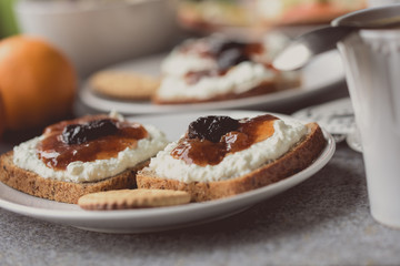 Breakfast with dark bread, white cheese , jam and coffee.  
